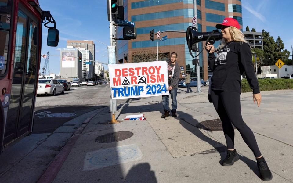 A protester holds a banner reading 'Destroy Marxism Trump 2024' in Los Angeles - ETIENNE LAURENT/Shutterstock