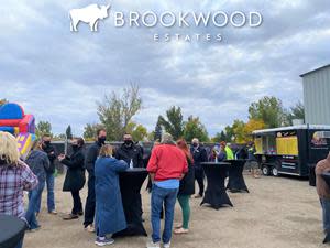 Residents and staff at Brookwood Estates gather over food and entertainment to celebrate their community's relaunch. Masks and sanitization were provided for all attendees.