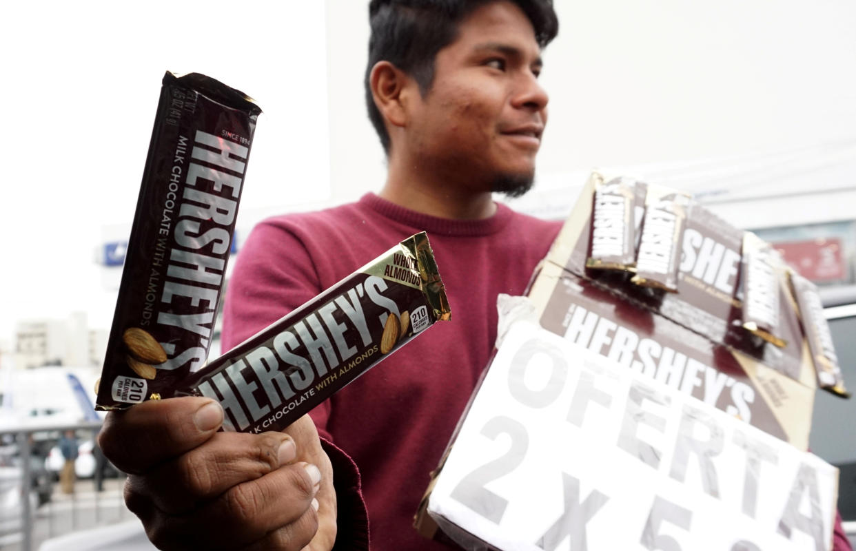 A street vendor sells Hershey's chocolate at a traffic junction in Lima, Peru.