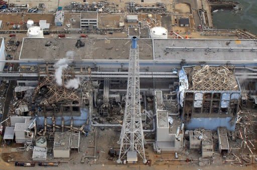 The stricken Tokyo Electric Power Company (TEPCO) Fukushima daiichi No.1 nuclear power plant reactor number three (L) and four (R), with smoke rising from number three at Okuma town in Fukushima prefecture. When Japanese farmer Hisashi Tarukawa watched the local nuclear plant blow up on television, he uttered a sentence that will forever chill his family: "Oh, no. It's over."