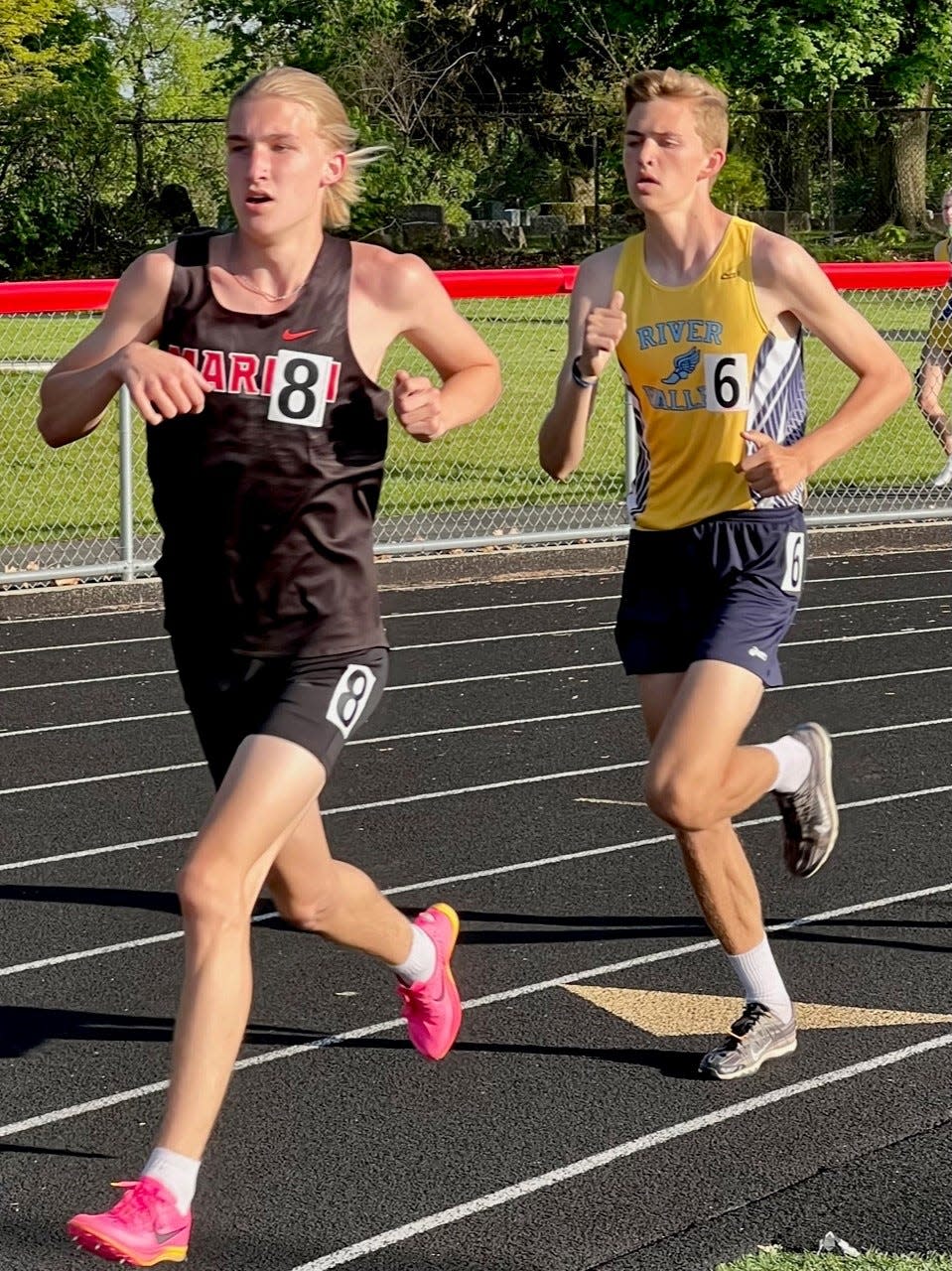 Marion Harding's Carter Ferguson leads River Valley's Chase Osborne in the boys 3200-meter run at the Mid Ohio Athletic Conference Championships last season in Harding Stadium.