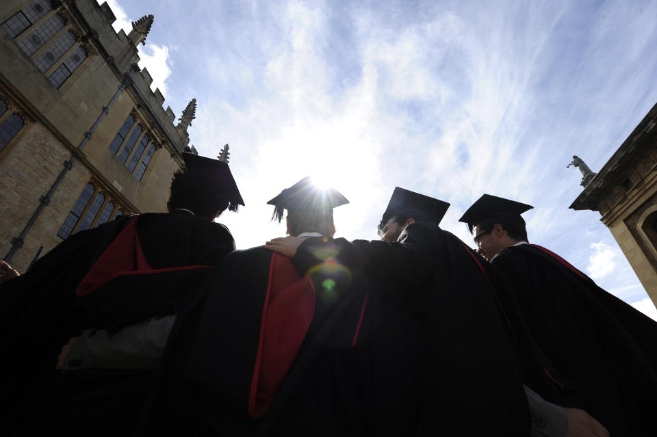 A group of graduates gather outside the Sheldonian Theatre