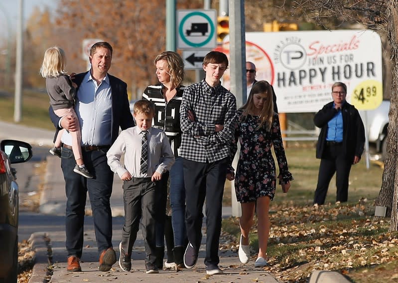 Conservative leader Andrew Scheer walks with his family on his way to vote in the federal election in Regina