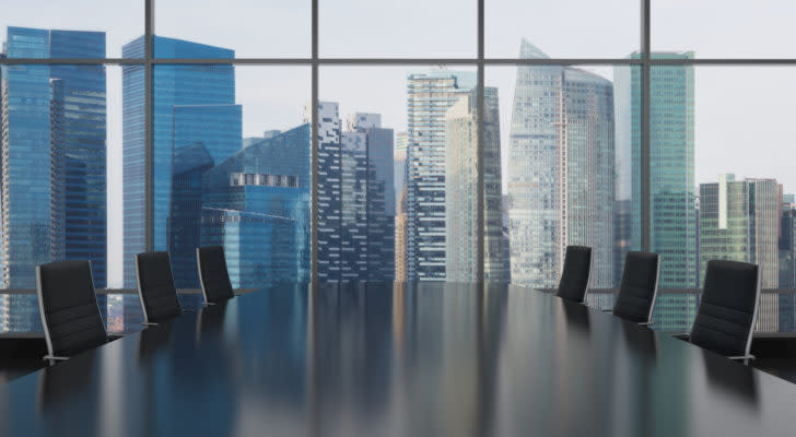 A photo of a large table in front of a large city window