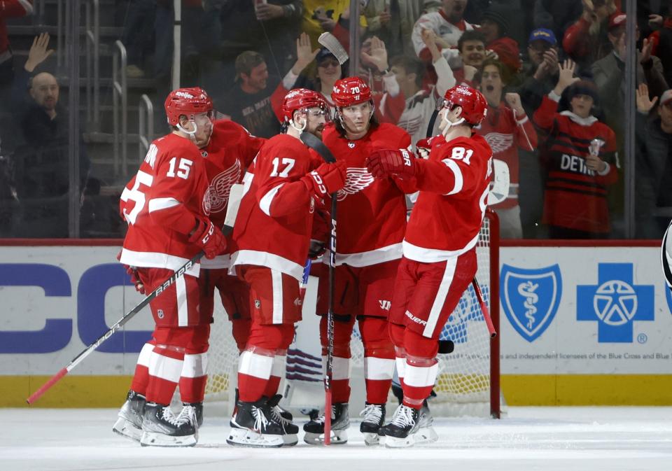 Detroit Red Wings defenseman Filip Hronek (17) celebrates with left wing Jakub Vrana (15), center Oskar Sundqvist (70) and left wing Dominik Kubalik (81) after scoring against the New York Rangers during the third period of an NHL hockey game Thursday, Feb. 23, 2023, in Detroit. (AP Photo/Duane Burleson)