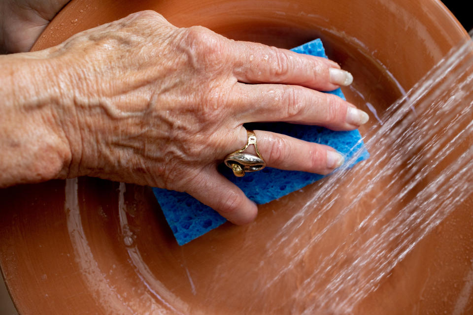 Image: Margo Woodacre washes dishes at home in Landenberg, Pa., on June 10, 2021. (Hannah Beier / for NBC News)