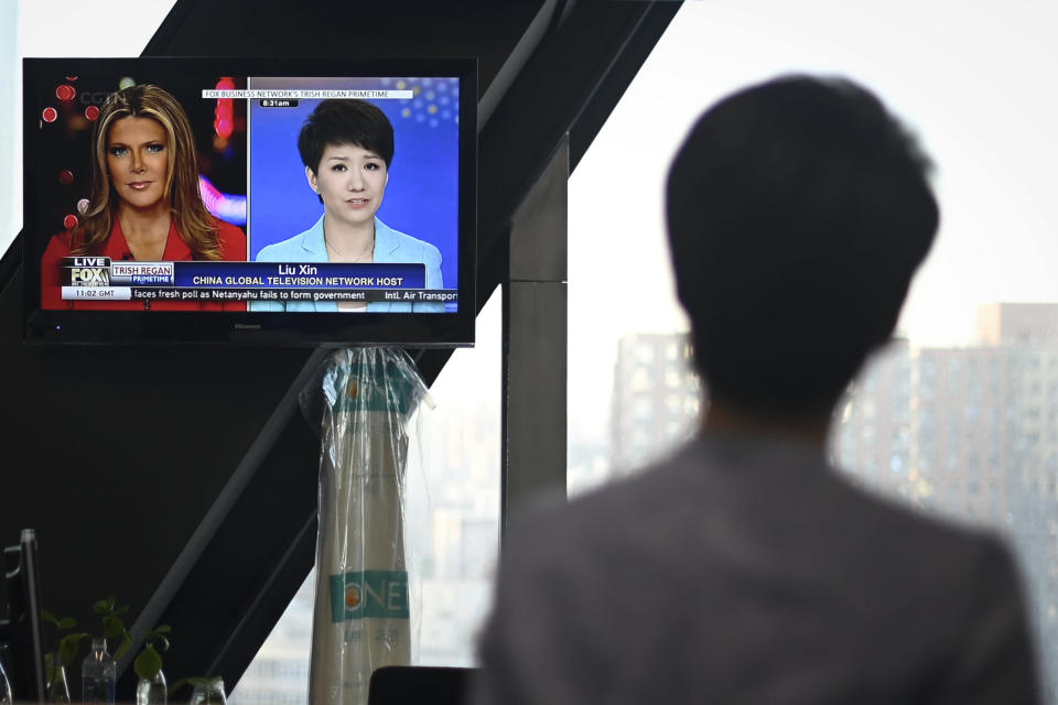 China's state broadcaster CGTN anchor Liu Xin looks at a screen showing her debate with Fox Business Network presenter Trish Regan, at the CCTV headquarters in Beijing on May 30, 2019. - A much-hyped war of words between Fox Business Network presenter Trish Regan and CGTN host Liu Xin left Chinese viewers disappointed as the trade debate on May 30 ended without the anticipated fireworks following a social media feud. (Photo by WANG ZHAO / AFP)        (Photo credit should read WANG ZHAO/AFP/Getty Images)