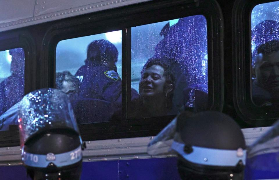 NYPD officers transport arrested students in a bus. AFP via Getty Images