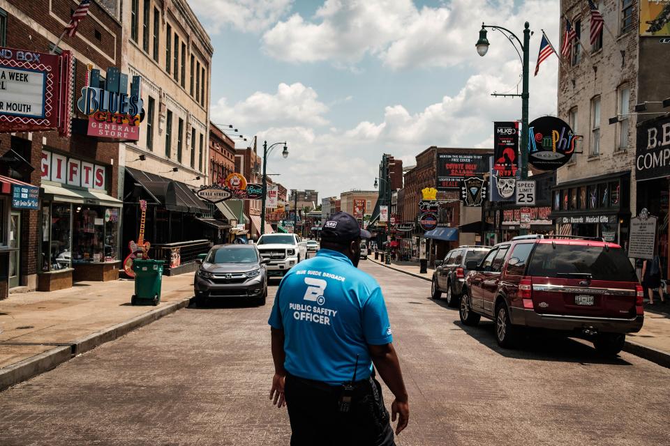 Capt. Eleslie Walker makes his way down Beale Street in downtown Memphis. The Blue Suede Brigade, a private security force, covers the entertainment district and popular tourist destination until 5 p.m., then Memphis police officers take over the beat.