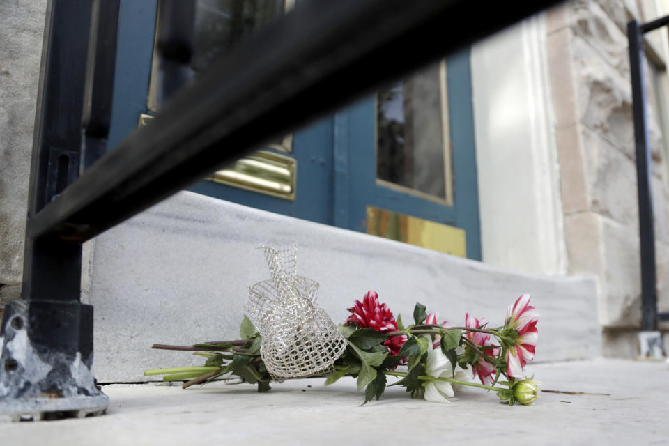 Flowers left by neighbor Mary Bianchi are seen on the doorstep to the home of U.S. Rep. Elijah Cummings, D-Md., Thursday, Oct. 17, 2019, in Baltimore. Cummings, a sharecropper's son who rose to become the powerful chairman of one of the U.S. House committees leading an impeachment inquiry of President Donald Trump, died Thursday, Oct. 17, 2019, of complications from longstanding health issues. He was 68. (AP Photo/Julio Cortez)