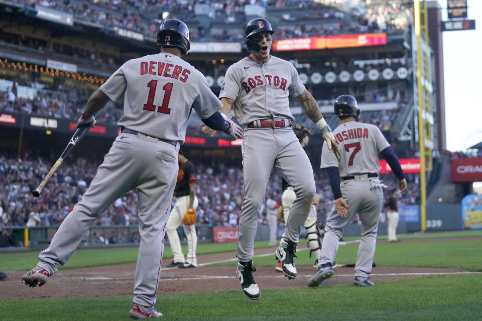 Boston Red Sox's Rafael Devers (11) celebrates after Jarren Duran, center, and Masataka Yoshida (7) scored on Justin Turner's two-run single during the ninth inning of a baseball game against the San Francisco Giants in San Francisco, Saturday, July 29, 2023. (AP Photo/Jeff Chiu)