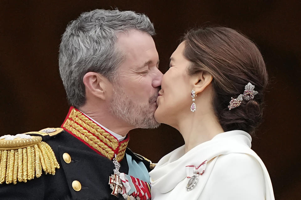 Denmark's King Frederik X kisses his wife Denmark's Queen Mary on the balcony of Christiansborg Palace in Copenhagen, Denmark, Sunday, Jan. 14, 2024. Queen Margrethe II has become Denmark's first monarch to abdicate in nearly 900 years when she handed over the throne to her son, who has become King Frederik X. (AP Photo/Martin Meissner)