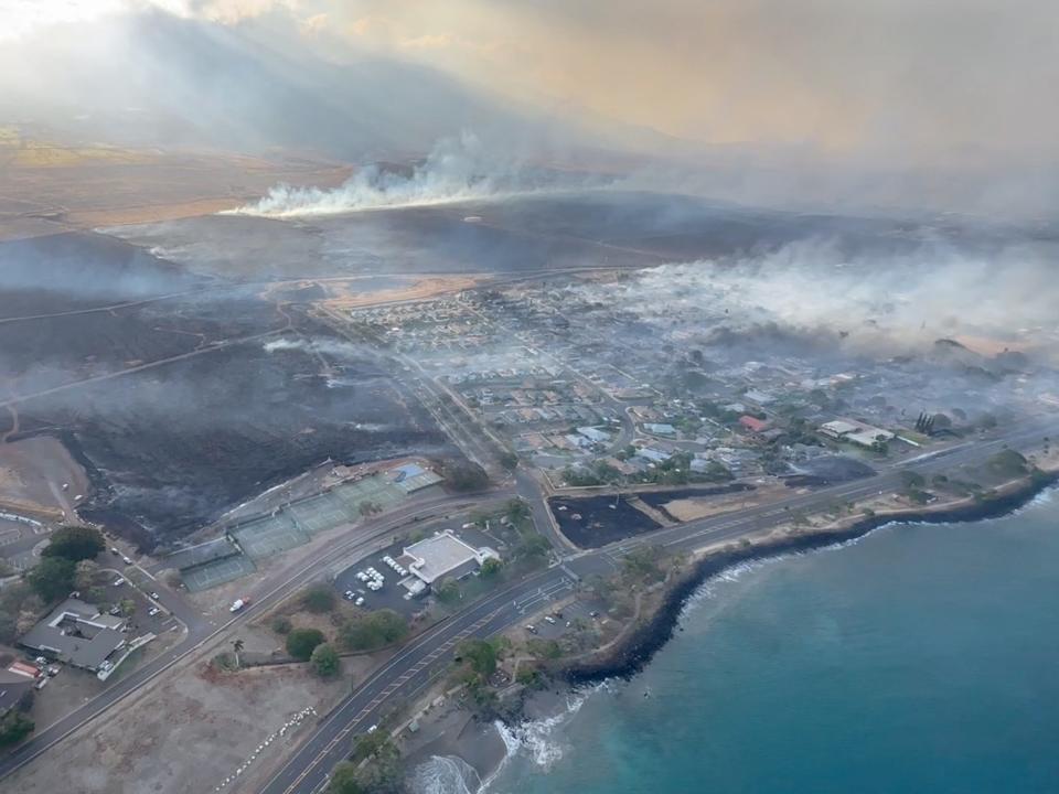 An aerial view as smoke rises from burnt areas amidst wildfires in Maui, Hawaii, U.S., August 9, 2023, in this screenshot taken from a social media video.