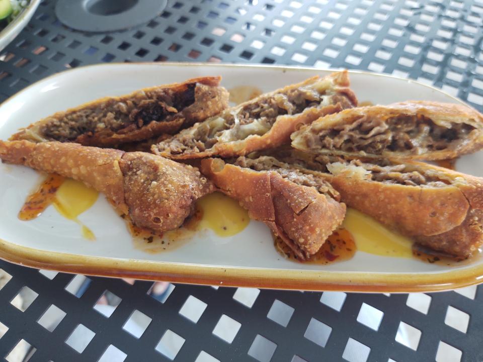 At the Seaside Grill in Vero Beach, the amazing Philly cheesesteak eggrolls are tender, juicy chopped steak and melted mozzarella cheese inside and a crispy, tender wrapper on the outside, dressed with dabbles of honey mustard and spicy sweet chili sauce.