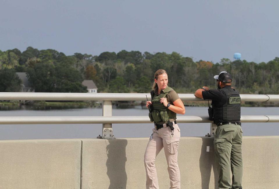 The Craven County Sheriff's Office look for possible evidence off the Neuse River Bridge after a reported pursuit of a known felon occurred around noon in New Bern, NC, Oct. 21, 2020. Traffic was detoured to a single lane west bound along US 17 at the scene. No other information about the situation is available at time of incident. [Gray Whitley / Sun Journal Staff]