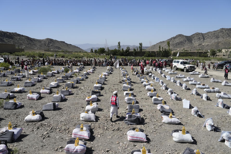 A humanitarian aid is lined up for distribution after an earthquake in Gayan village, in Paktika province, Afghanistan, Friday June 24, 2022. A powerful earthquake struck a rugged, mountainous region of eastern Afghanistan early Wednesday, flattening stone and mud-brick homes in the country's deadliest quake in two decades, the state-run news agency reported. (AP Photo/Ebrahim Nooroozi)