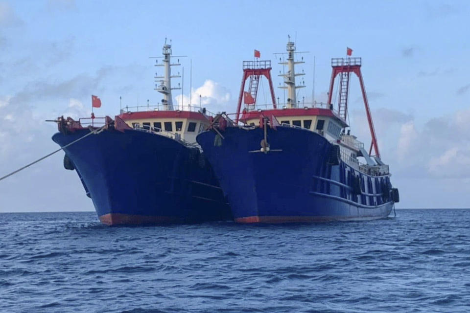 In this photo provided by the National Task Force-West Philippine Sea, Chinese vessels are moored at Whitsun Reef, South China Sea on March 27, 2021. The Philippine government said Wednesday, March 31, that more than 250 Chinese vessels it believes are operated by militia have been spotted near six Manila-claimed islands and reefs in the disputed South China Sea and demanded that China immediately remove them. (National Task Force-West Philippine Sea via AP)