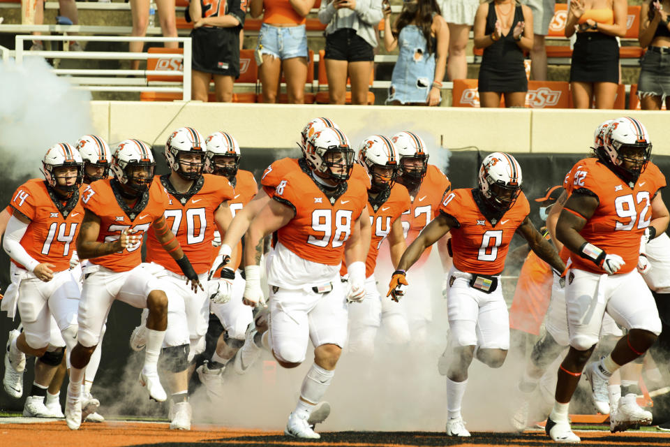 Oklahoma State players take the field before an NCAA college football game against Tulsa, Saturday, Sept. 19, 2020, in Stillwater, Okla. (AP Photo/Brody Schmidt)