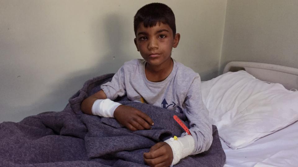 Ten-year old Thaier Nadm sits in his hospital bed in Erbil after a mortar attack near Mosul. (Photo: Ash Gallagher for Yahoo News)