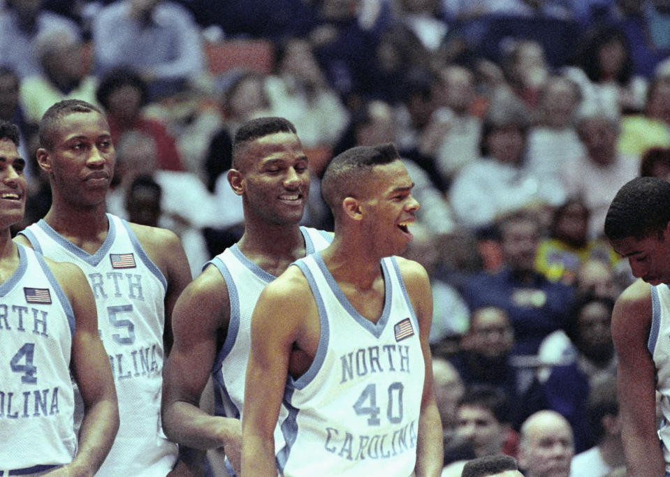 North Carolina players react to certain victory late in their 93-67 win over Eastern Michigan during East Regional semi-finals at the Meadowlands in East Rutherford, N.J., March 23, 1991. From left: Rick Fox, Clifford Rozier, George Lynch and Hubert Davis. The Tar Heels meet Temple in Sunday’s final. (AP Photo/Bill Kostroun)