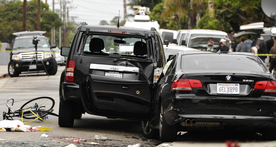 A wrecked black BMW sedan is pictured on the street after series of drive-by shootings that left 6 people dead in the Isla Vista section of Santa Barbara