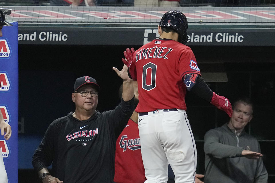 Cleveland Guardians manager Terry Francona, left, greets Andres Gimenez (0), who returns to the dugout after hitting a home run against the Kansas City Royals during the second inning of a baseball game Thursday, July 6, 2023, in Cleveland. (AP Photo/Sue Ogrocki)