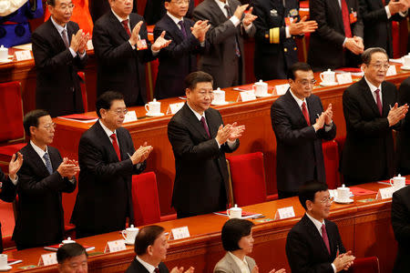 Chinese President Xi Jinping, Chinese Premier Li Keqiang and other top officials clap their hands during the closing session of the National People's Congress (NPC) at the Great Hall of the People in Beijing, China March 20, 2018. REUTERS/Damir Sagolj