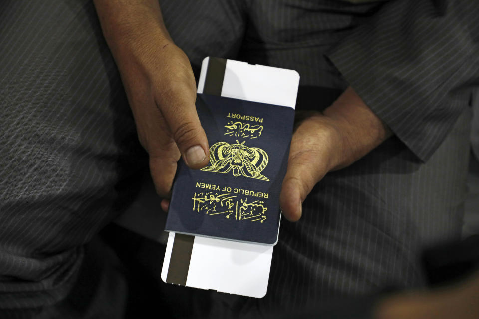 A Yemeni man holds his passport as he waits in departure lounge at Sanaa International airport, Yemen, Monday, Feb. 3, 2020. A United Nations medical relief flight carrying patients from Yemen's rebel-held capital took off Monday, the first such aid flight in over three years. (AP Photo/Hani Mohammed)
