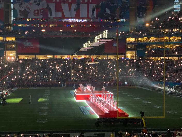 Rihanna waits atop the stage for the start of her Super Bowl halftime show.