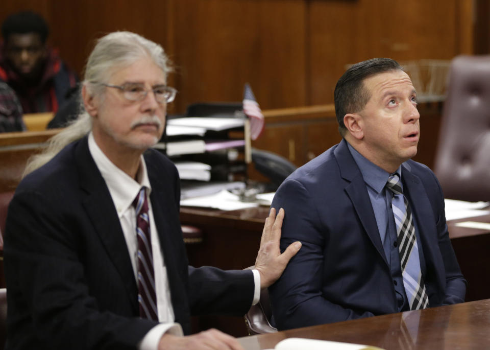 While attorney Ron Kuby, left, listens, Johnny Hincapie reacts in the courtroom in New York, Wednesday, Jan. 25, 2017. Prosecutors dropped a case Wednesday against Hincapie, who spent a quarter-century behind bars in an infamous tourist killing before getting his conviction overturned. (AP Photo/Seth Wenig)