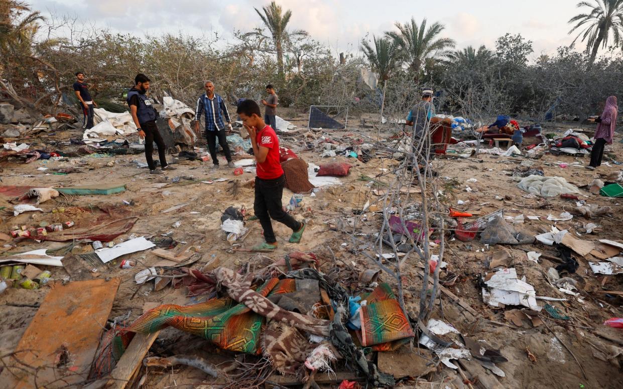 A young boy inspects a tent camp which was hit in an Israeli airstrike in Khan Younis, southern Gaza