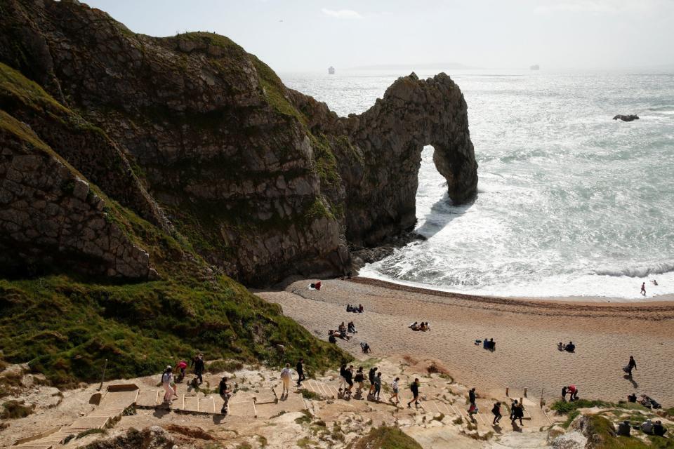 Durdle Door in Lulworth continued to attract visitors on Saturday (REUTERS)