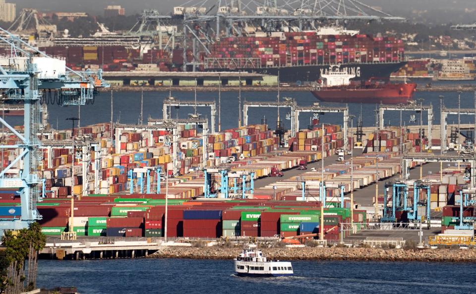 Cargo containers wait to be transported after being offloaded at the Port of Los Angeles, Oct 16, 2021, in San Pedro, Calif. Supply chain issues have caused shortages of goods throughout the country with cargo ships waiting offshore in Southern California to offload.