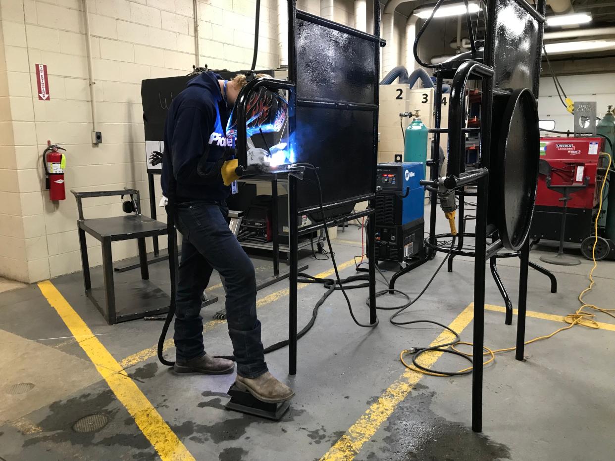 Aaron Cover, a senior from Wynford High School, welds part of the jungle gym at Pioneer Career and Technology Center.