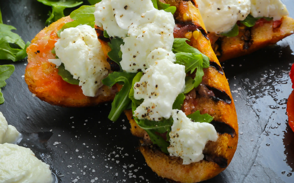 <p>Parade</p><p>This Spanish-inspired tomato bread is topped with burrata and arugula for the perfect breakfast!</p><p><strong>Get the recipe: <a href="https://parade.com/689637/jonashton/toasted-tomato-bread-with-burrata-and-arugula/" rel="nofollow noopener" target="_blank" data-ylk="slk:Toasted Tomato Bread with Burrata and Arugula;elm:context_link;itc:0;sec:content-canvas" class="link rapid-noclick-resp"><em>Toasted Tomato Bread with Burrata and Arugula</em></a></strong></p>