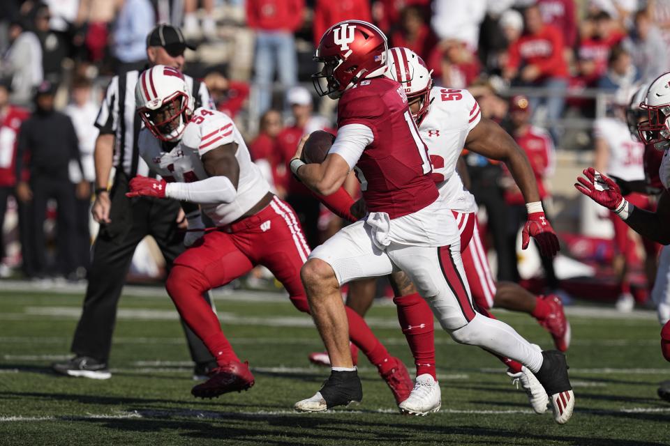 Indiana quarterback Brendan Sorsby (15) runs past Wisconsin linebacker Jordan Turner (54) runs during the second half of an NCAA college football game, Saturday, Nov. 4, 2023, in Bloomington, Ind. (AP Photo/Darron Cummings)