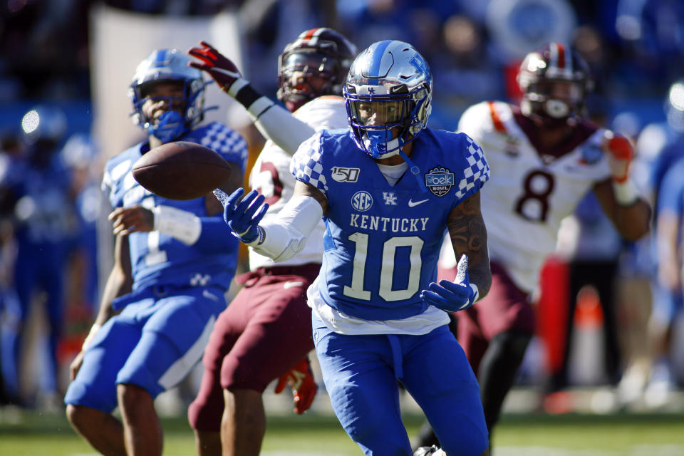 Kentucky running back Asim Rose (10) fumbles the ball against Virginia Tech in the first half of the Belk Bowl NCAA college football game in Charlotte, N.C., Tuesday, Dec. 31, 2019. He recovered the fumble. (AP Photo/Nell Redmond)