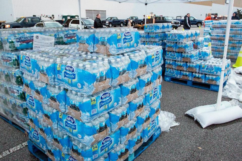 The GeStamp Stamping Plant-South Charleston (W.Va.) is one of several distribution locations open Sunday morning, Jan. 12, 2014 so local residents can pick up bottled water and fill containers after a chemical spill Thursday in the Elk River that has contaminated the public water supply in nine counties. Frustration is mounting for many of the 300,000 West Virginia residents who've gone three days without clean tap water..This location will remain open 24-hours a day until the ban on using tap water for drinking and washing is lifted. (AP Photo Michael Switzer)