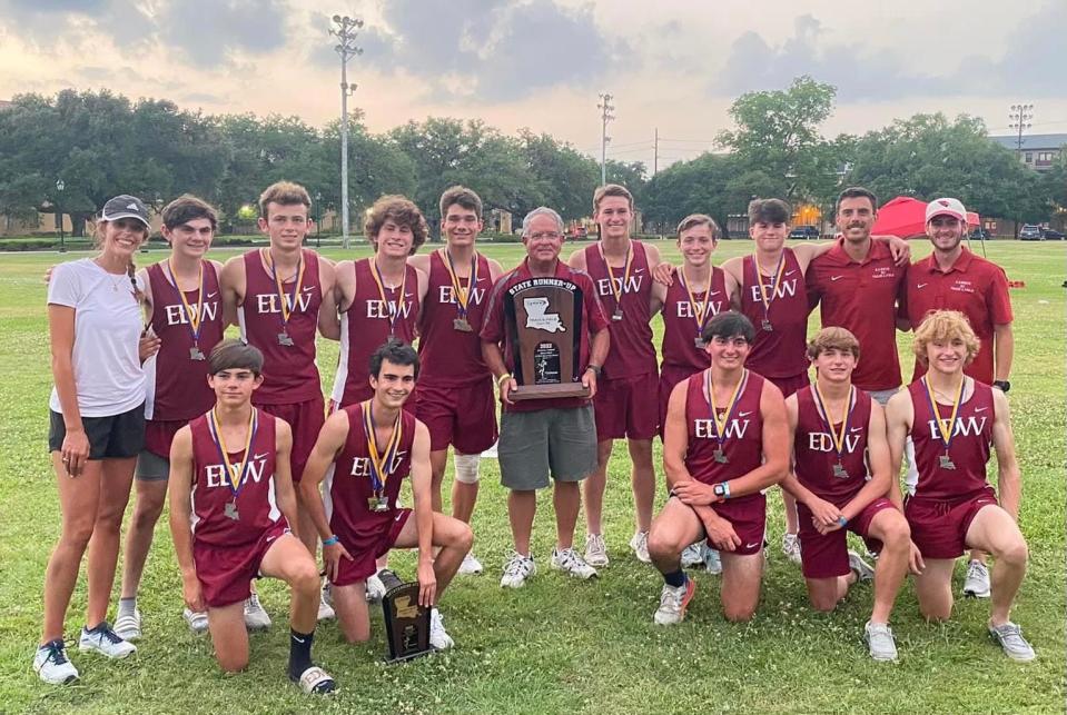 E.D. White track and field coach Don Grabert (middle) holds the Class 4A state runner-up trophy after the LHSAA state outdoor track and field meet at Bernie Moore Track Complex in Baton Rouge on May 7.