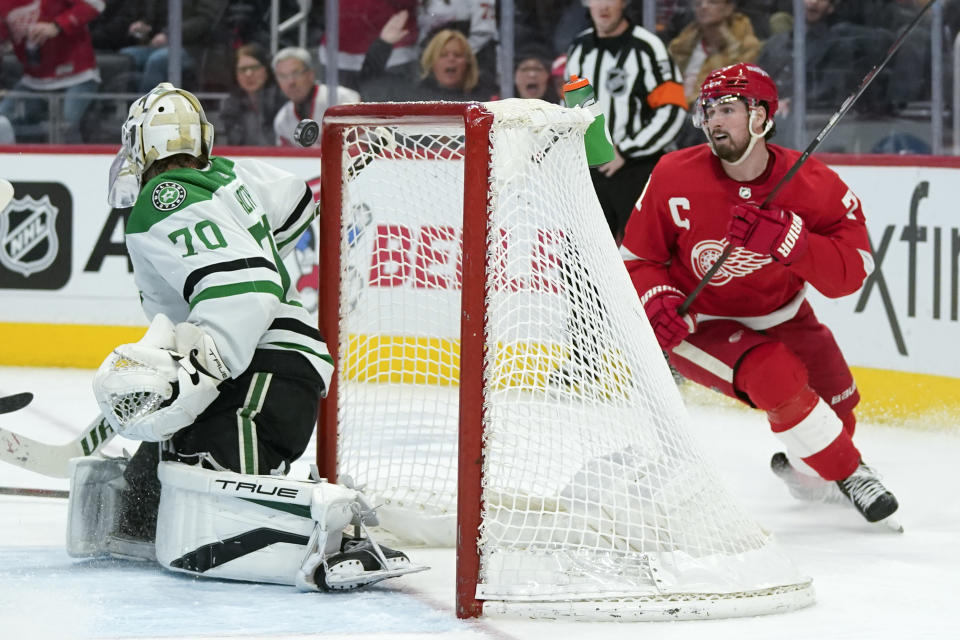 Detroit Red Wings center Dylan Larkin (71) watches his shot drop for a goal on Dallas Stars goaltender Braden Holtby (70) in the second period of an NHL hockey game Friday, Jan. 21, 2022, in Detroit. (AP Photo/Paul Sancya)