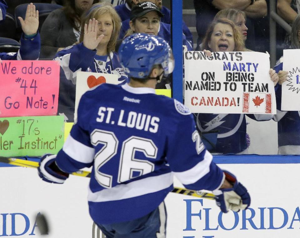 FILE - In this Feb. 6, 2014 file photo, a fan holds up a sign congratulating Tampa Bay Lightning right winger Martin St. Louis (26) for being selected to the Canadian Olympic hockey team before an NHL hockey game against the Toronto Maple Leafs, in Tampa, Fla. The New York Rangers and Lightning are pulling off the first major deal on NHL trade deadline day, Wednesday, March 5, 2014, swapping captains Ryan Callahan and Martin St. Louis. (AP Photo/Chris O'Meara, F