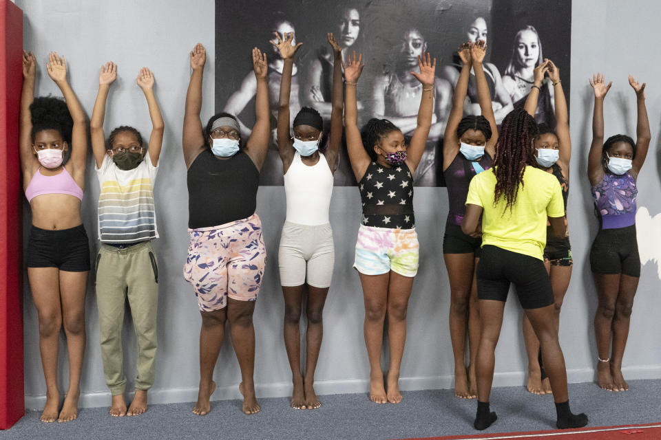 Girls participate in a gymnastics camp, Thursday, July 22, 2021, at Power Moves Gymnastics and Fitness in Cedarhurst, N.Y. The face of gymnastics in the United States is changing. There are more athletes of color starting — and sticking — in a sport long dominated by white athletes at the highest levels. (AP Photo/Mark Lennihan)