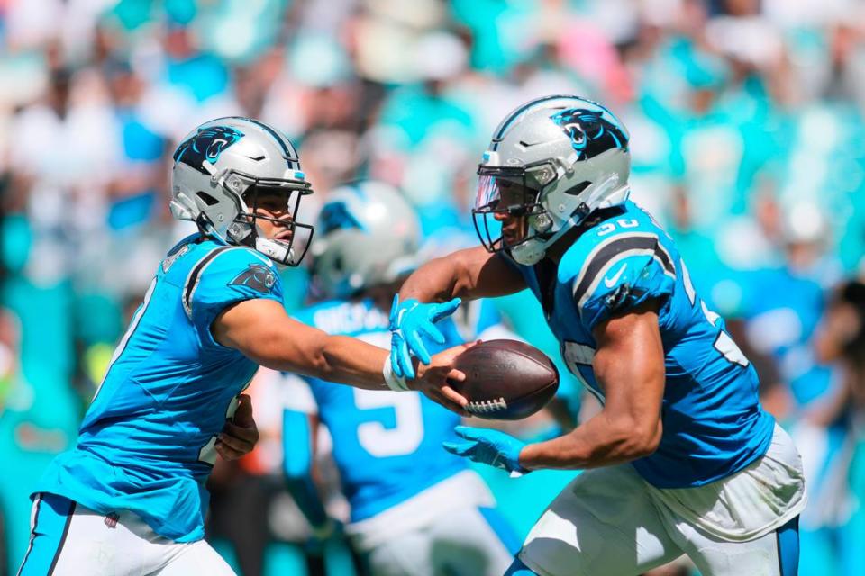 Oct 15, 2023; Miami Gardens, Florida, USA; Carolina Panthers quarterback Bryce Young (9) gives the football to running back Chuba Hubbard (30) during the second quarter at Hard Rock Stadium. Mandatory Credit: Sam Navarro-USA TODAY Sports