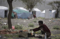 <p>A displaced man cooks food outside his tent at a camp for internally displaced people in the outskirts of Sanaa, Yemen, Friday, May 27, 2016. Yemen’s conflict pits the government, backed by the Saudi-led coalition, against Shiite rebels known as Houthis allied with a former president. Yemen’s war has killed at least 6,200 civilians and injured tens of thousands of Yemenis, and 2.4 million people have been displaced, according to U.N. figures. (AP Photo/Hani Mohammed) </p>
