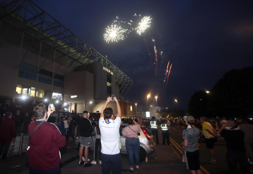 Leeds United fans celebrate outside Elland Road after Huddersfield Town beat West Bromwich Albion to seal their promotion to the Premier League.