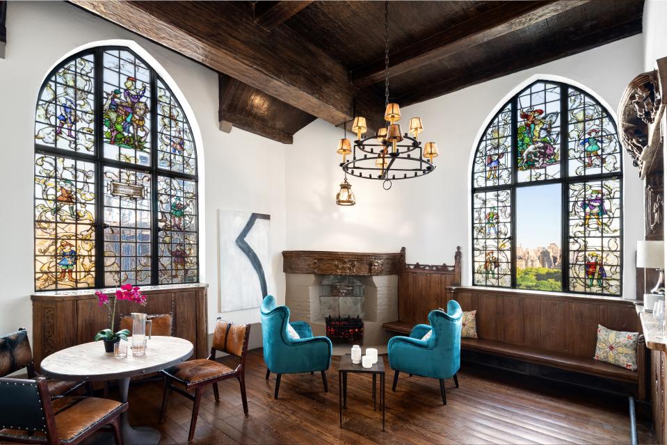 Residents of the penthouse get access to this unique tower, which features a wet bar, fireplace, and stained glass windows with views of Central Park.