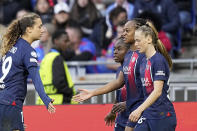 PSG's Marie-Antoinette Katoto, 2nd right, is congratulated by Eva Gaetino after scoring her side's second goal during the women's Champions League semifinals, first leg, soccer match between Olympique Lyonnais and Paris Saint-Germain at Parc Olympique Lyonnais, in Lyon, France, Saturday, April 20, 2024. (AP Photo/Laurent Cipriani)