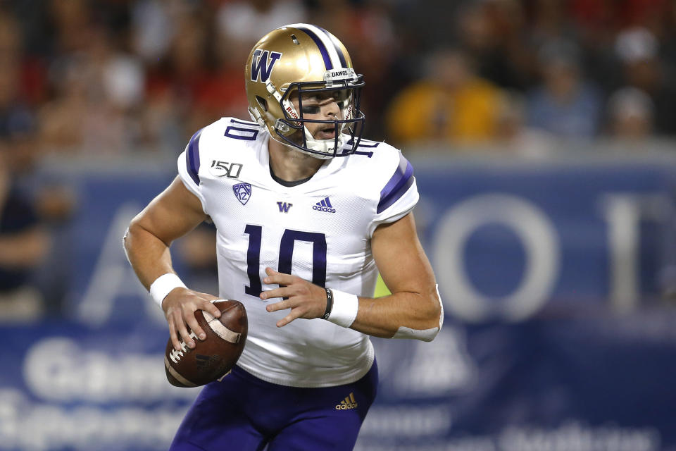 Washington quarterback Jacob Eason looks for a receiver during the first half of the team's NCAA college football game against Arizona on Saturday, Oct. 12, 2019, in Tucson, Ariz. (AP Photo/Rick Scuteri)