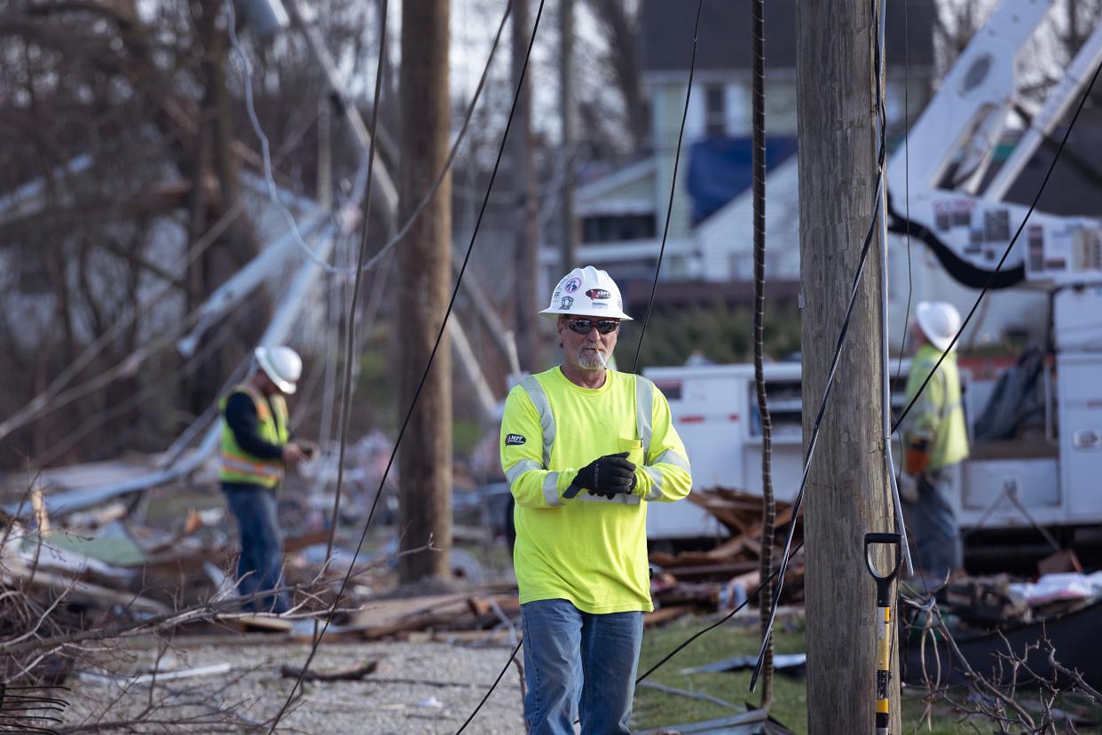 WINCHESTER, INDIANA - MARCH 15: Linemen work to restore power lines after a tornado on March 15, 2024 in Winchester, Indiana. At least three people have been reported killed after a series of tornadoes ripped through the midwest yesterday.