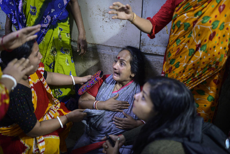 Family members of a victim in a fire that broke out at a commercial complex react in a hospital in Dhaka, Bangladesh, Friday, March 1, 2024. Bangladesh's health minister says a fire in a six-story commercial complex in the nation's capital, Dhaka, has killed several people and injured dozens of others. (AP Photo/Mahmud Hossain Opu)